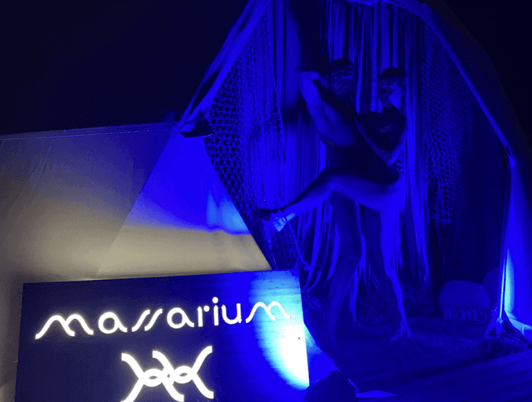 Blue-lit Massarium stage with performer