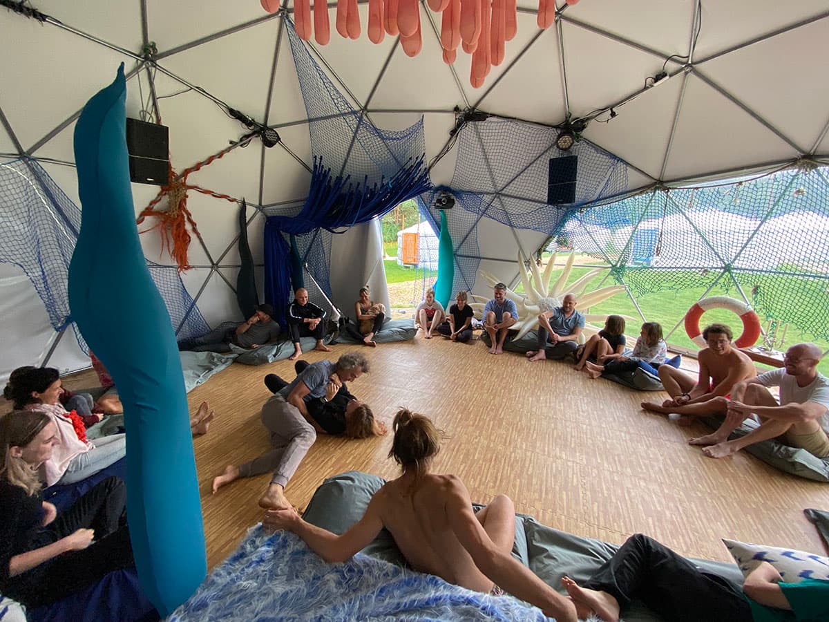 Participants sitting in a circle inside the Massarium dome during a workshop